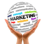 13933981 - hands holding a marketing word sphere on white background.