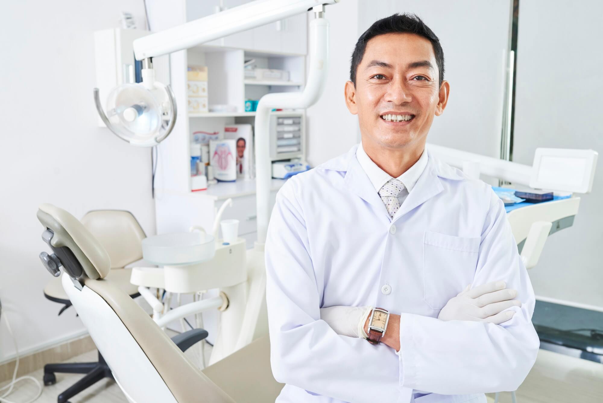 Cheerful Dentist With Arns Crossed