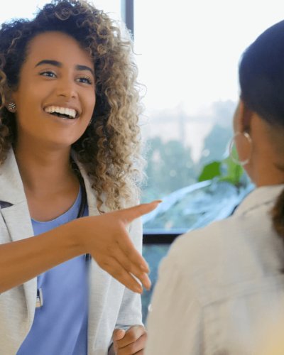 Lady smiling shaking hand